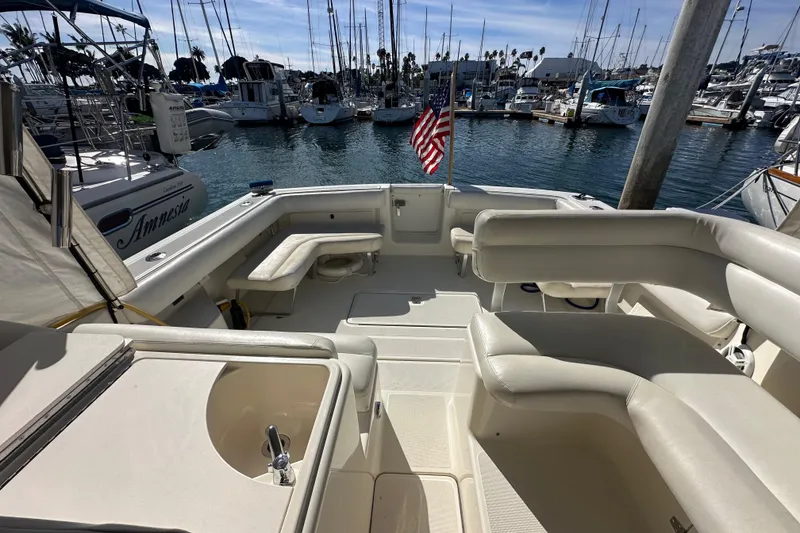 Slide: The Image of 1998 Tiara Yachts 2900 Coronet interior, featuring spacious seating and marina view. - 10