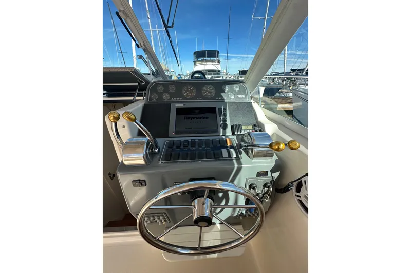 Slide: The Image of 1998 Tiara Yachts 2900 Coronet helm with steering wheel and navigation controls. - 14