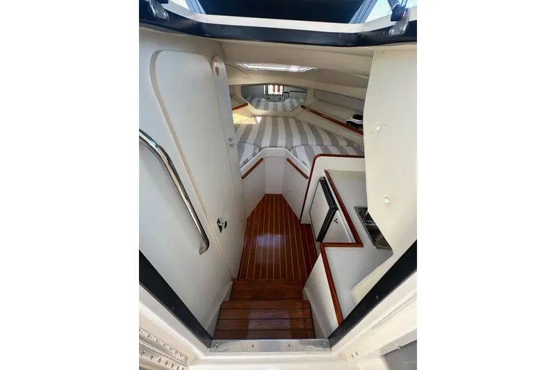 Slide: The Image of Interior view of 1998 Tiara Yachts 2900 Coronet cabin with wood flooring and striped upholstery. - 19