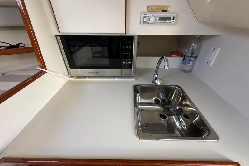 Slide: The Image of Compact kitchenette in a 1998 Tiara Yachts 2900 Coronet with sink and microwave. - 26