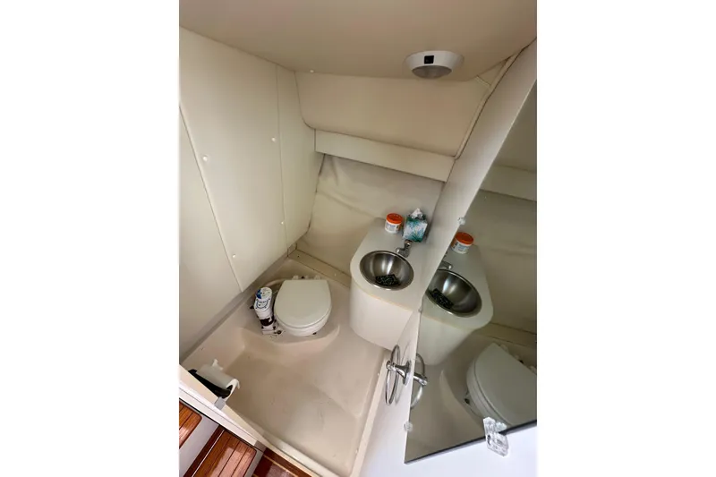 Slide: The Image of 1998 Tiara Yachts 2900 Coronet bathroom with toilet, sink, and mirror. - 29