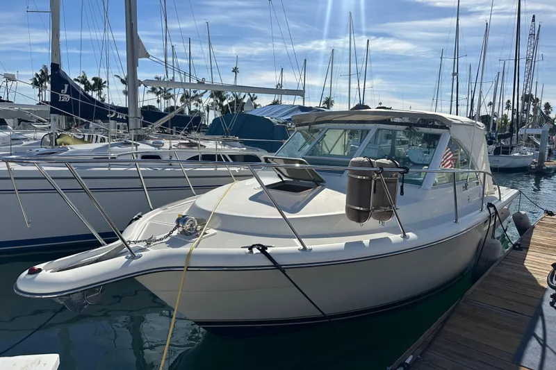 Slide: The Image of 1998 Tiara Yachts 2900 Coronet docked at marina under clear blue sky. - 3