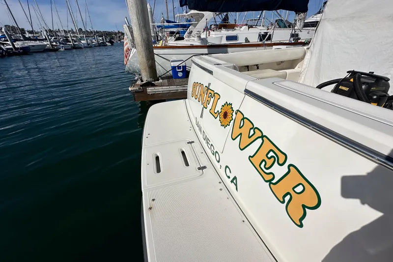 Slide: The Image of 1998 Tiara Yachts 2900 Coronet docked, featuring "Sunflower" name in San Diego marina. - 33