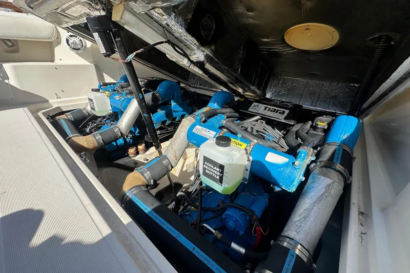 Slide: The Image of Engine compartment of a 1998 Tiara Yachts 2900 Coronet, showcasing dual blue engines. - 34