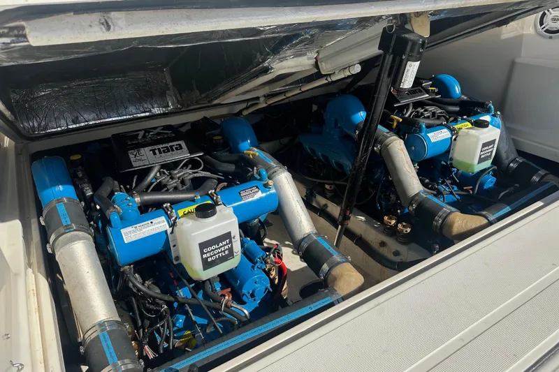Slide: The Image of Engine compartment of a 1998 Tiara Yachts 2900 Coronet, showcasing dual blue engines. - 35
