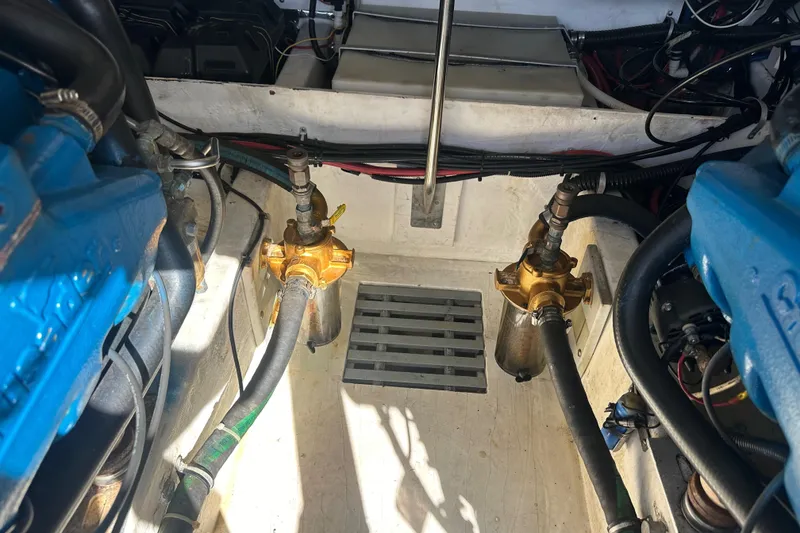 Slide: The Image of Engine compartment of a 1998 Tiara Yachts 2900 Coronet, showcasing mechanical components and hoses. - 36