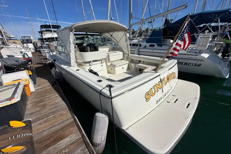 Slide: The Image of 1998 Tiara Yachts 2900 Coronet docked, featuring "SUNFLOWER" name and American flag. - 4