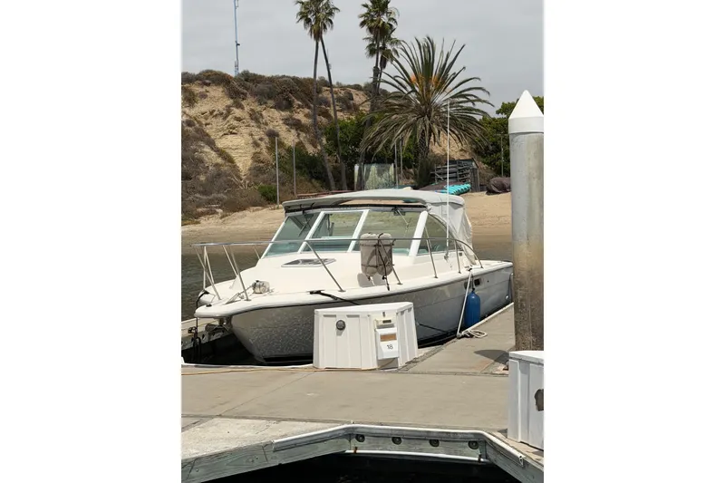 Slide: The Image of 1998 Tiara Yachts 2900 Coronet docked near palm trees on a sunny day. - 44