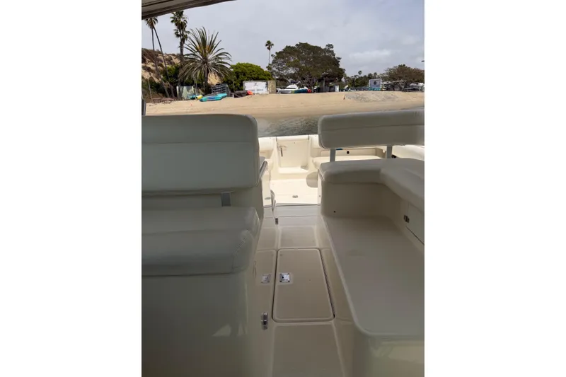 Slide: The Image of 1998 Tiara Yachts 2900 Coronet interior view with seating, near a sandy beach. - 49