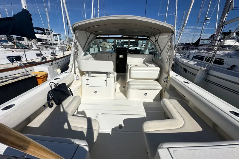 Slide: The Image of 1998 Tiara Yachts 2900 Coronet interior view, docked at marina with seating and canopy. - 5