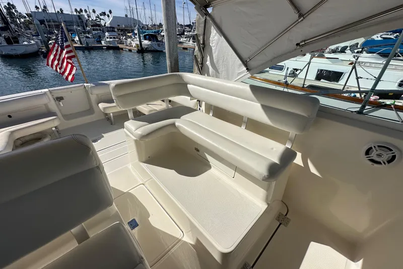 Slide: The Image of 1998 Tiara Yachts 2900 Coronet interior with seating, docked at marina with American flag. - 9