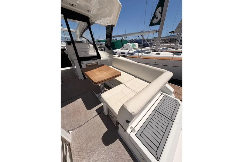 Slide: The Image of 2020 Cruisers Yachts 390 Express Coupe interior with seating and wooden table. - 16