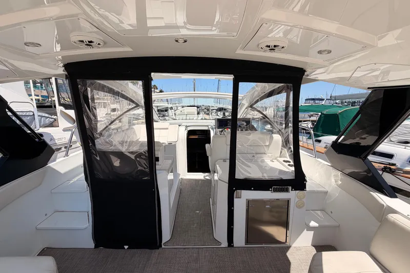 Slide: The Image of 2020 Cruisers Yachts 390 Express Coupe interior with seating and marina view. - 17