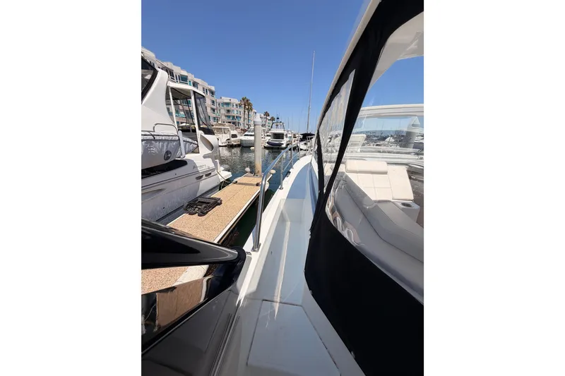 Slide: The Image of 2020 Cruisers Yachts 390 Express Coupe docked at marina, side view. - 20