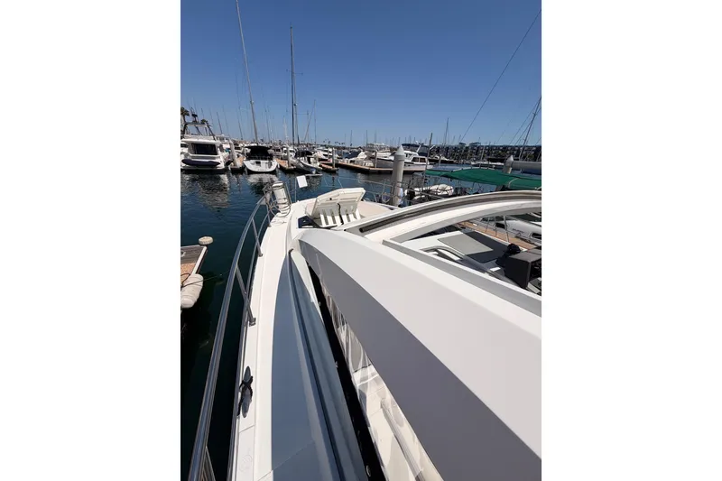 Slide: The Image of 2020 Cruisers Yachts 390 Express Coupe docked in a marina under clear blue skies. - 21
