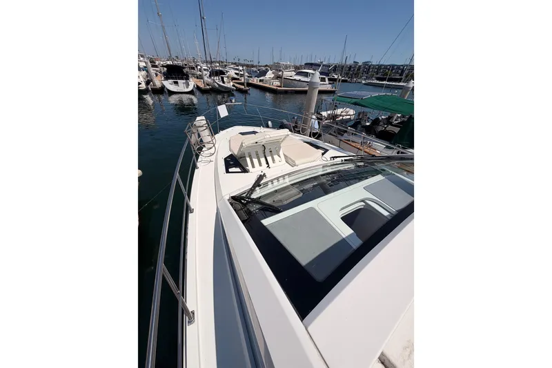 Slide: The Image of 2020 Cruisers Yachts 390 Express Coupe docked in a marina, showcasing sleek design. - 22