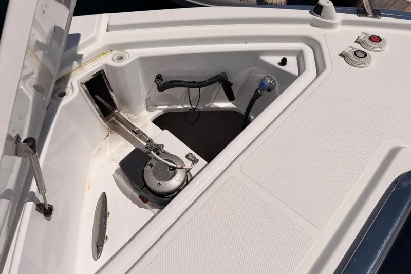 Slide: The Image of 2020 Cruisers Yachts 390 Express Coupe anchor compartment with winch and controls. - 24