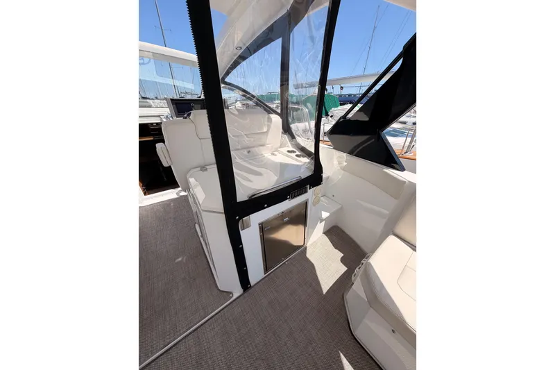 Slide: The Image of 2020 Cruisers Yachts 390 Express Coupe interior with seating and clear enclosure. - 29