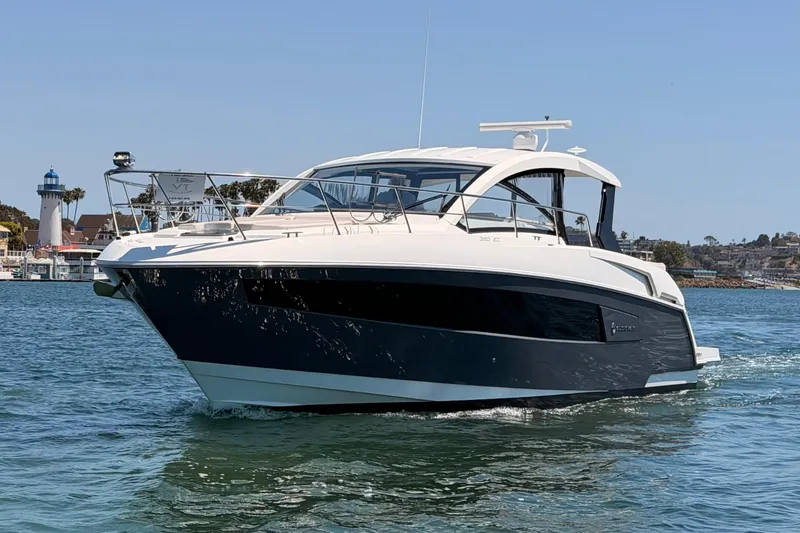 Slide: The Image of 2020 Cruisers Yachts 390 Express Coupe on water near lighthouse. - 3