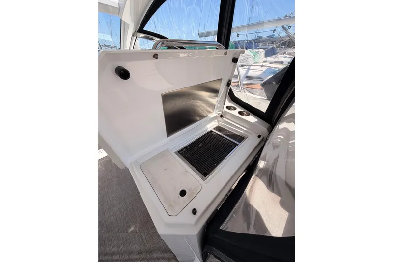 Slide: The Image of Outdoor kitchen area on 2020 Cruisers Yachts 390 Express Coupe, featuring a grill and sink. - 31