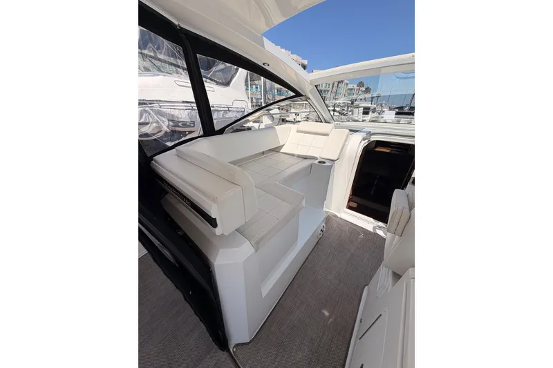 Slide: The Image of 2020 Cruisers Yachts 390 Express Coupe interior with white seating and open cockpit view. - 33