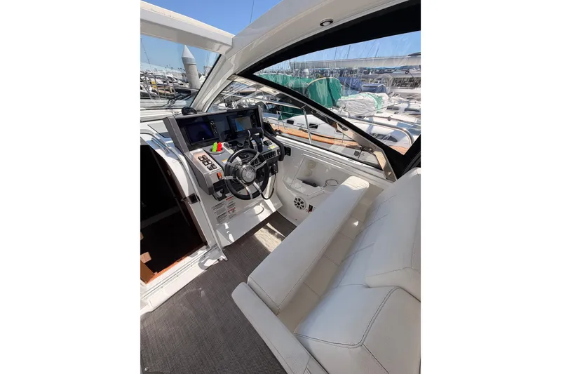 Slide: The Image of 2020 Cruisers Yachts 390 Express Coupe cockpit with modern controls and plush seating. - 35