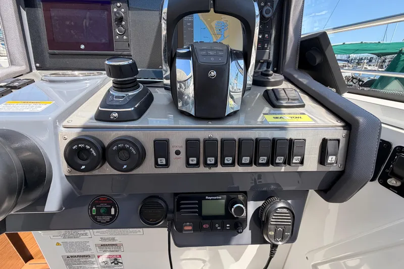 Slide: The Image of Control panel of a 2020 Cruisers Yachts 390 Express Coupe with navigation and communication equipment. - 37
