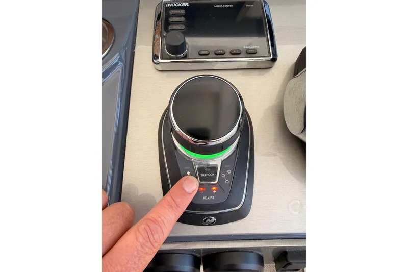 Slide: The Image of Control panel of 2020 Cruisers Yachts 390 Express Coupe with joystick and media center. - 38