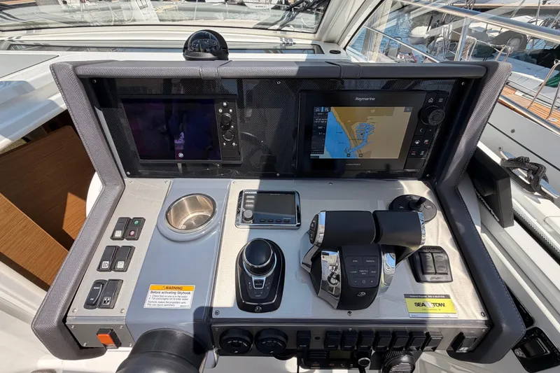 Slide: The Image of Control panel of 2020 Cruisers Yachts 390 Express Coupe with navigation screens and controls. - 39