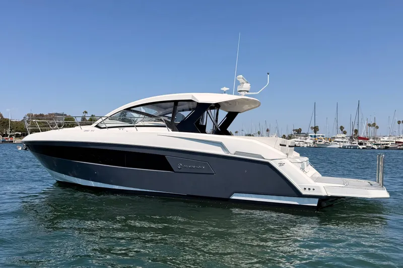 Slide: The Image of 2020 Cruisers Yachts 390 Express Coupe on water, sleek design, marina background. - 4
