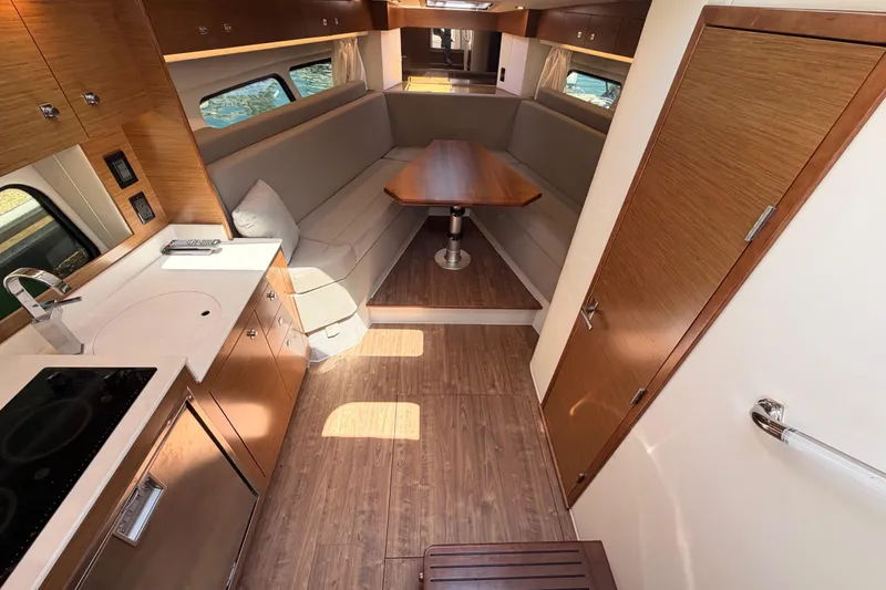 Slide: The Image of Interior of 2020 Cruisers Yachts 390 Express Coupe, featuring modern kitchen and cozy seating area. - 44