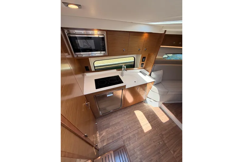 Slide: The Image of Interior of 2020 Cruisers Yachts 390 Express Coupe, featuring modern kitchen amenities. - 45