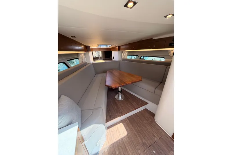 Slide: The Image of Interior of 2020 Cruisers Yachts 390 Express Coupe with elegant seating and wooden table. - 46
