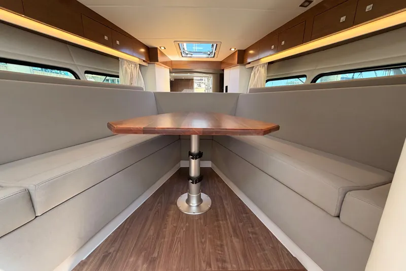 Slide: The Image of Interior of 2020 Cruisers Yachts 390 Express Coupe with elegant seating and wooden table. - 47