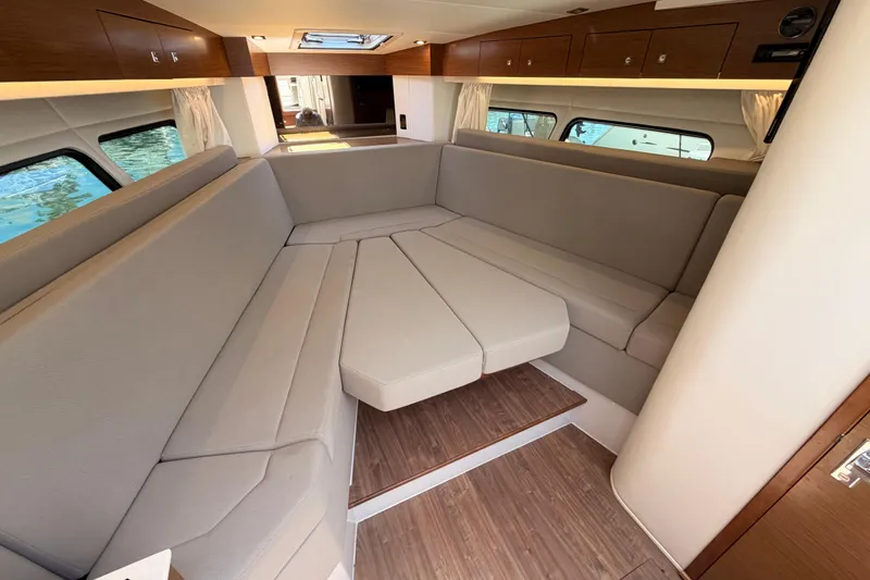 Slide: The Image of Interior of 2020 Cruisers Yachts 390 Express Coupe with elegant seating and wood accents. - 48