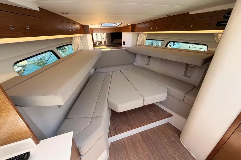 Slide: The Image of Interior of 2020 Cruisers Yachts 390 Express Coupe, featuring elegant seating and wood accents. - 49