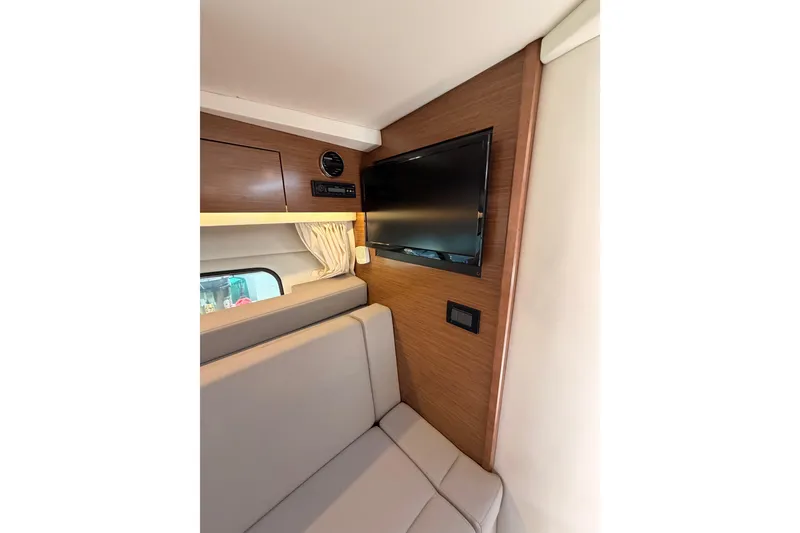 Slide: The Image of Interior of 2020 Cruisers Yachts 390 Express Coupe with TV and seating area. - 50