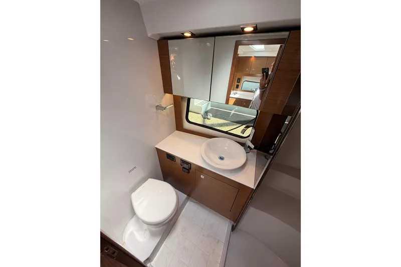 Slide: The Image of Modern bathroom in 2020 Cruisers Yachts 390 Express Coupe with sleek fixtures and wood accents. - 52