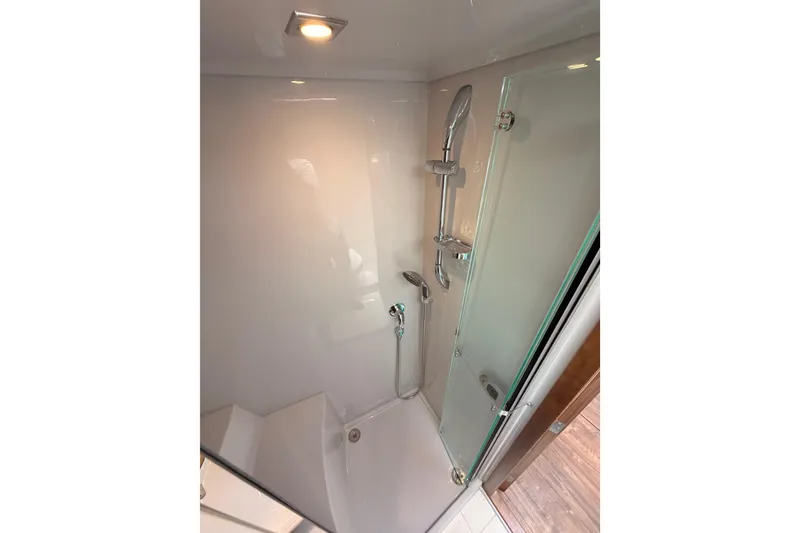 Slide: The Image of Shower area in 2020 Cruisers Yachts 390 Express Coupe, featuring modern fixtures and glass door. - 53