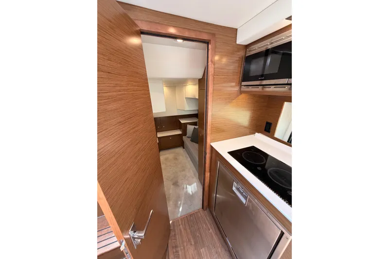 Slide: The Image of Interior of 2020 Cruisers Yachts 390 Express Coupe, featuring modern kitchen and cozy cabin. - 56