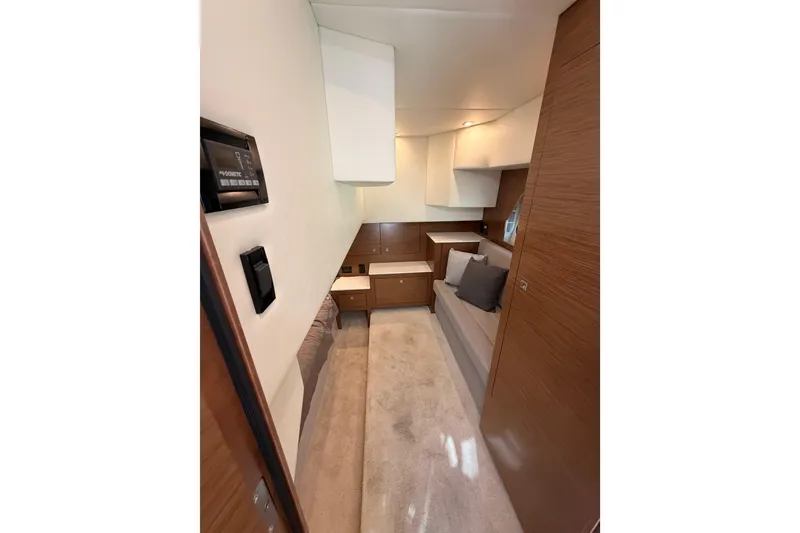 Slide: The Image of Interior of 2020 Cruisers Yachts 390 Express Coupe, featuring modern wood finishes and cozy seating. - 57