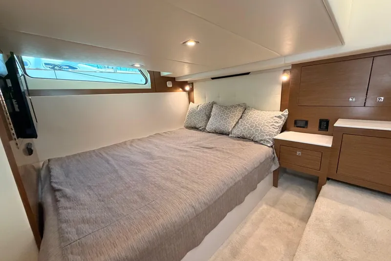 Slide: The Image of Luxurious cabin interior of 2020 Cruisers Yachts 390 Express Coupe with cozy bedding and modern design. - 59