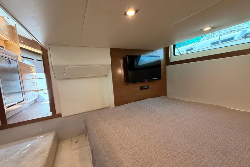 Slide: The Image of Interior cabin of 2020 Cruisers Yachts 390 Express Coupe with bed and TV. - 60