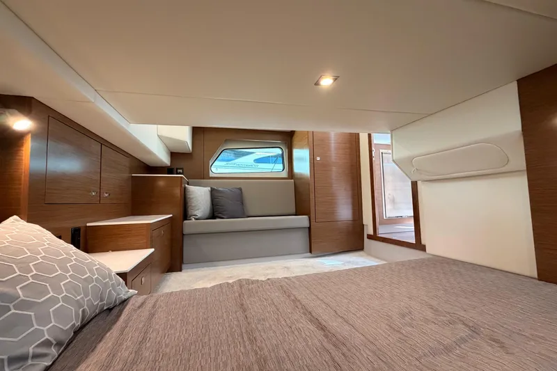 Slide: The Image of Luxurious interior of 2020 Cruisers Yachts 390 Express Coupe, featuring modern wood finishes and cozy seating. - 61