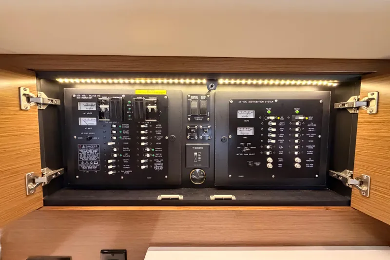 Slide: The Image of Electrical control panel inside 2020 Cruisers Yachts 390 Express Coupe, featuring switches and indicators. - 64