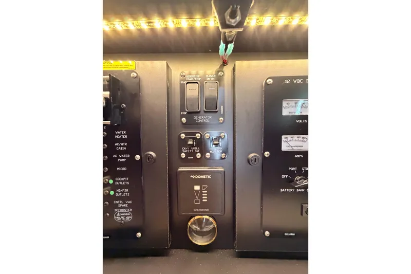 Slide: The Image of Control panel of 2020 Cruisers Yachts 390 Express Coupe with switches and indicators. - 66