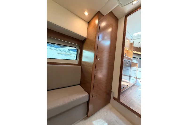 Slide: The Image of Interior of 2020 Cruisers Yachts 390 Express Coupe, featuring modern wood paneling and seating. - 69