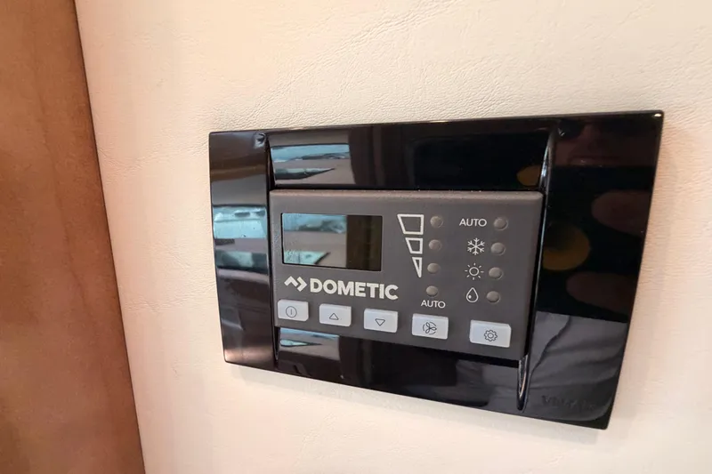 Slide: The Image of Dometic control panel in 2020 Cruisers Yachts 390 Express Coupe interior. - 70