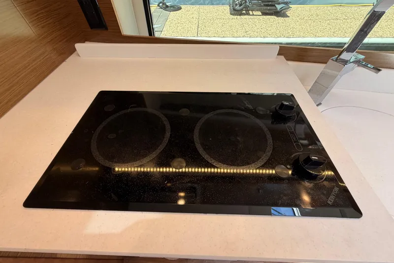 Slide: The Image of Modern stovetop in 2020 Cruisers Yachts 390 Express Coupe kitchen area. - 71