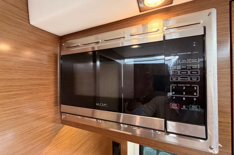 Slide: The Image of Built-in microwave in 2020 Cruisers Yachts 390 Express Coupe kitchen area. - 72